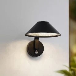 Lindby LED-væglampe Capelo, sort, metal, sensor, Ø20cm