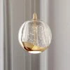 Lucande LED-pendellampe Hayley, Ø 9 cm, guldfarvet, glas