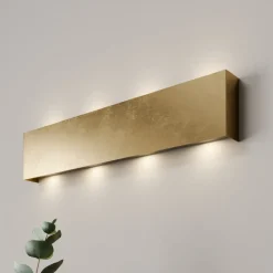 Quitani LED-væglampe Maja, guld antik, bredde 54 cm